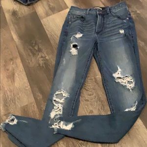 Distressed dark blue skinny jeans